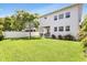 Spacious backyard with lush green grass and tropical foliage surrounding the home at 3616 W Anderson Ave, Tampa, FL 33611