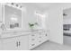 Bright bathroom showcasing double sinks, white cabinetry, and modern lighting fixtures at 3616 W Anderson Ave, Tampa, FL 33611