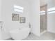 Bright bathroom featuring a freestanding tub, a glass-enclosed shower, and clean, modern lines at 3616 W Anderson Ave, Tampa, FL 33611