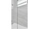 Close-up of a modern bathtub and shower with elegant marble-look tile surround at 3616 W Anderson Ave, Tampa, FL 33611