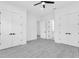 Bright bedroom with light gray wood floors, ceiling fan and bright white trim at 3616 W Anderson Ave, Tampa, FL 33611