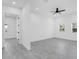 Bright bedroom with tile floors, ceiling fan, and natural light from large windows at 3616 W Anderson Ave, Tampa, FL 33611