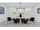 This dining room features modern lighting, bright windows, and neutral colors at 3616 W Anderson Ave, Tampa, FL 33611