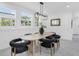 Bright dining area featuring modern light fixture and light wood flooring at 3616 W Anderson Ave, Tampa, FL 33611