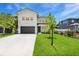 Two-story modern home featuring a well-manicured lawn and a two car garage at 3616 W Anderson Ave, Tampa, FL 33611