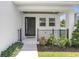 Inviting front porch with a modern door, manicured landscaping, and a welcoming entrance at 3616 W Anderson Ave, Tampa, FL 33611