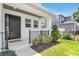 A charming front porch with black iron railings, fresh landscaping, and a dark-colored front door at 3616 W Anderson Ave, Tampa, FL 33611