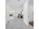 Hallway leading to a living room, kitchen, and dining area in an open-concept design at 3616 W Anderson Ave, Tampa, FL 33611