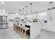 Spacious modern kitchen boasts a large island with seating, sleek white cabinets, and ample counter space at 3616 W Anderson Ave, Tampa, FL 33611