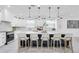 Bright kitchen with white cabinets, an island with bar stool seating and pendant lights at 3616 W Anderson Ave, Tampa, FL 33611