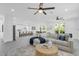 Open living area connected to a kitchen and dining area with light gray wood-look floors at 3616 W Anderson Ave, Tampa, FL 33611