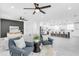 Stylish living room with modern furniture, accent wall, and an open view of the contemporary kitchen at 3616 W Anderson Ave, Tampa, FL 33611