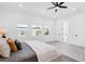 Bright bedroom features large windows, gray wood-look floors, white walls, and gray upholstered headboard at 3616 W Anderson Ave, Tampa, FL 33611