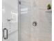 Modern shower with glass door and white marble tile at 3616 W Anderson Ave, Tampa, FL 33611