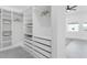Spacious walk-in closet with shelving, drawers and abundant storage space at 3616 W Anderson Ave, Tampa, FL 33611