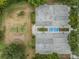 Aerial view showcasing tennis, basketball, and volleyball courts surrounded by beautiful mature landscaping at 4320 Auston Way, Palm Harbor, FL 34685