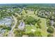 Scenic aerial view of Lansbrook Golf Course, showcasing the lush greens, trees and neighborhood at 4320 Auston Way, Palm Harbor, FL 34685