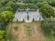 An aerial view reveals a basketball and volleyball court framed by mature landscaping at 4320 Auston Way, Palm Harbor, FL 34685