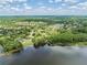 Scenic aerial shot featuring neighborhood bordering the water, showcasing wooden dock and lush vegetation at 4320 Auston Way, Palm Harbor, FL 34685