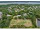 This aerial shot offers mature landscaping, the playground, and the residences of the neighborhood at 4320 Auston Way, Palm Harbor, FL 34685