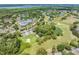 Scenic aerial view of Lansbrook Golf Course with trees, ponds, fairways and water views at 4320 Auston Way, Palm Harbor, FL 34685