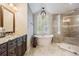 Contemporary bathroom showcasing a soaking tub beneath a window and a glass-enclosed shower at 4320 Auston Way, Palm Harbor, FL 34685