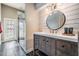 Stylish bathroom featuring shiplap accent wall, glass shower, and wood vanity with vessel sink at 4320 Auston Way, Palm Harbor, FL 34685