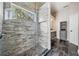 Modern bathroom featuring stone tile shower with glass enclosure and updated vanity at 4320 Auston Way, Palm Harbor, FL 34685