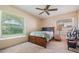 Cozy bedroom with natural light, ceiling fan, and dark wood furniture at 4320 Auston Way, Palm Harbor, FL 34685