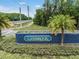 Lansbrook community signage with lush landscaping and views of the roadway at 4320 Auston Way, Palm Harbor, FL 34685