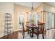 Bright dining area featuring a round table, natural lighting, and an access door to the outdoor patio at 4320 Auston Way, Palm Harbor, FL 34685