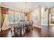 Elegant dining room with hardwood floors, shutters, and decorative chandelier at 4320 Auston Way, Palm Harbor, FL 34685