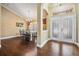 Beautiful foyer leading to a dining area with hardwood floors and elegant decor at 4320 Auston Way, Palm Harbor, FL 34685