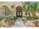 Charming home exterior featuring lush landscaping and a welcoming entrance at 4320 Auston Way, Palm Harbor, FL 34685
