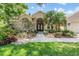 Charming home exterior featuring lush landscaping and a welcoming entrance at 4320 Auston Way, Palm Harbor, FL 34685