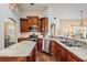 Gourmet kitchen with granite countertops, stainless steel appliances, and custom cabinetry at 4320 Auston Way, Palm Harbor, FL 34685