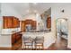 Spacious kitchen featuring wooden cabinetry, stainless steel appliances, granite counters, and bar seating at 4320 Auston Way, Palm Harbor, FL 34685