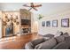 Comfortable living room showcasing a stone fireplace, hardwood floors, and neutral décor at 4320 Auston Way, Palm Harbor, FL 34685