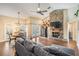 Inviting living room with a stone fireplace, ceiling fan, and access to the dining area and outdoor space at 4320 Auston Way, Palm Harbor, FL 34685