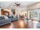Open-concept living room seamlessly connected to the kitchen and dining area, featuring hardwood floors and natural light at 4320 Auston Way, Palm Harbor, FL 34685