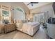 Serene main bedroom with high ceilings, a king-size bed, and access to the outdoor patio at 4320 Auston Way, Palm Harbor, FL 34685