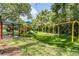 Community playground area with swings, slide, picnic shelter, and green space at 4320 Auston Way, Palm Harbor, FL 34685