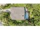 Aerial view of home featuring a screened-in pool, patio, and lush landscaping at 4797 Stonebriar Dr, Oldsmar, FL 34677