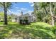 Expansive backyard featuring a screened-in pool and lush landscaping at 4797 Stonebriar Dr, Oldsmar, FL 34677