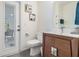 Bathroom with a modern vanity, toilet, and door leading to an outdoor patio at 4797 Stonebriar Dr, Oldsmar, FL 34677
