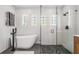 Bright bathroom featuring a freestanding tub, glass shower, and modern fixtures at 4797 Stonebriar Dr, Oldsmar, FL 34677