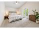 Well-lit bedroom with a ceiling fan, a white comforter, and French doors at 4797 Stonebriar Dr, Oldsmar, FL 34677