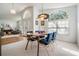 Elegant dining area adjacent to the living room, featuring modern furniture and ample natural light at 4797 Stonebriar Dr, Oldsmar, FL 34677