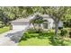 Charming home featuring a well-manicured lawn, arched windows, and a blue front door at 4797 Stonebriar Dr, Oldsmar, FL 34677