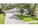 Charming home featuring a well-manicured lawn, arched windows, and a blue front door at 4797 Stonebriar Dr, Oldsmar, FL 34677
